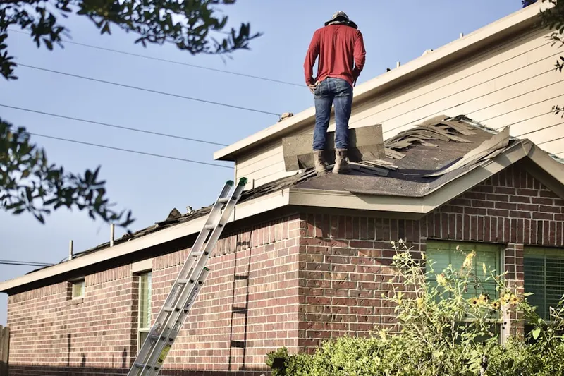 Professional roofer working on a residential roof in Downtown Goleta